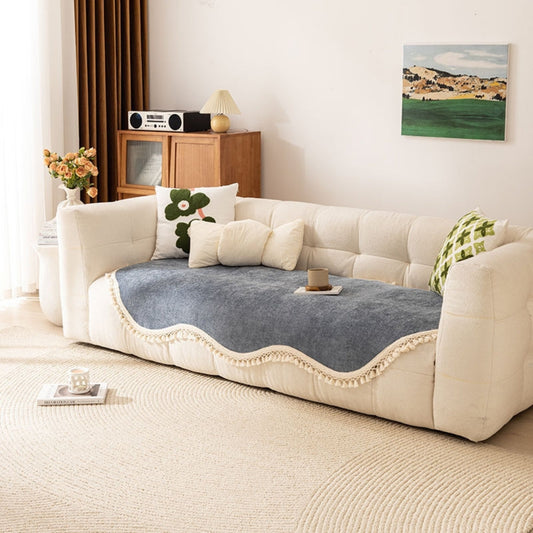 Elegant sofföverdrag i chenille med moderna tofsar